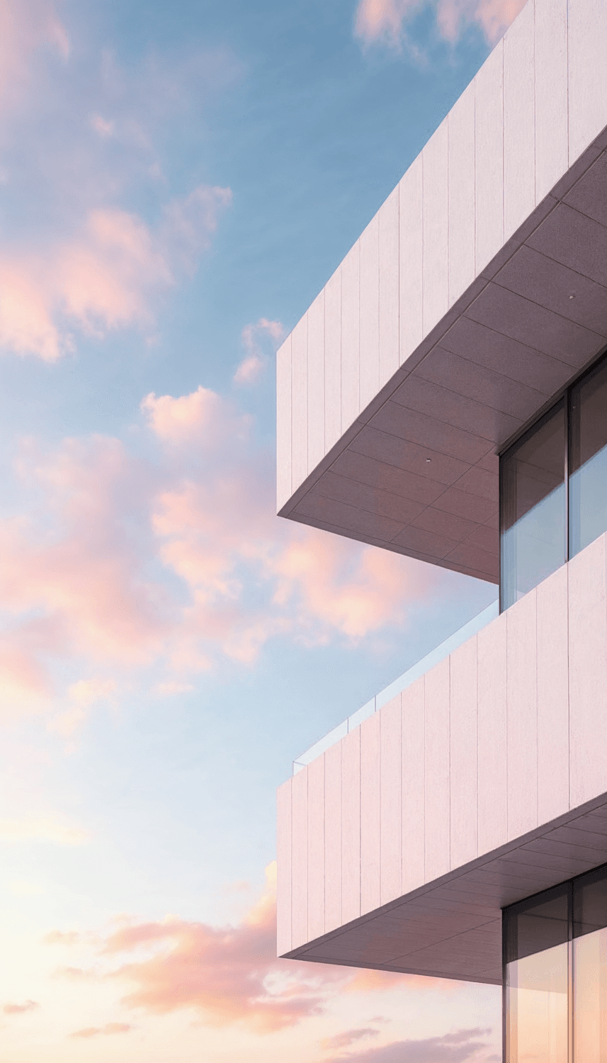 Upper floors of a panelled facade against a pink evening sky