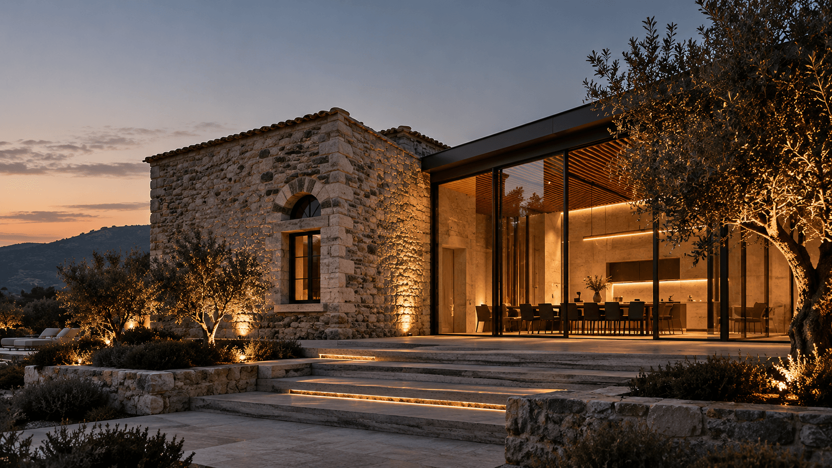 Maison Calcaire at dusk, the restored stone wine house joined to a new glass tasting room